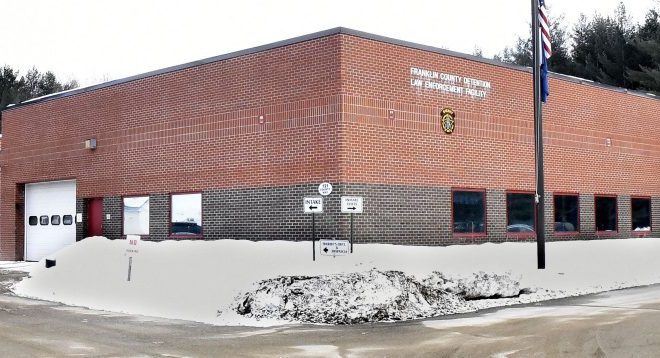 A cruiser exits the Franklin County Jail in Farmington beside the sheriff's office Tuesday. Town and county officials are discussing what they say is a lack for funding for the jail.