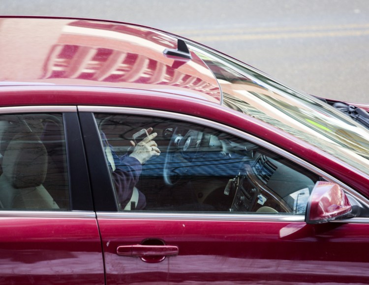 A short stretch of Temple Street in downtown Portland yields no shortage of drivers using their hand-held devices behind the wheel in this 2017 photo. 