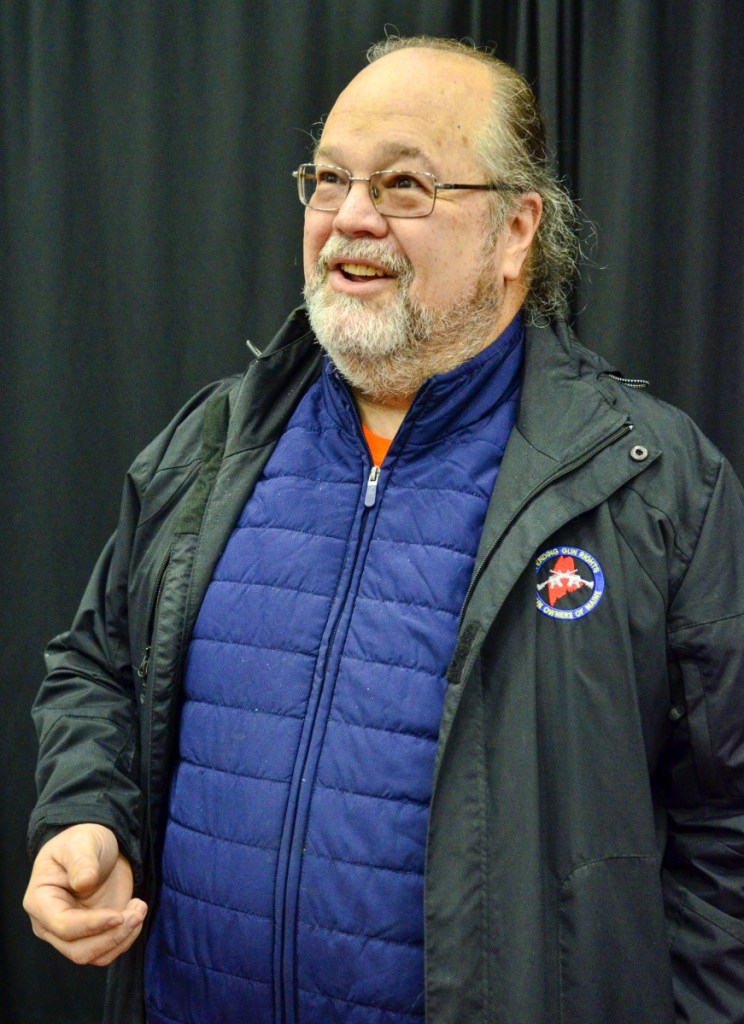 Todd Tolhurst, president of the Gun Owners of Maine, answers questions during a gun show Saturday at the Augusta Civic Center.