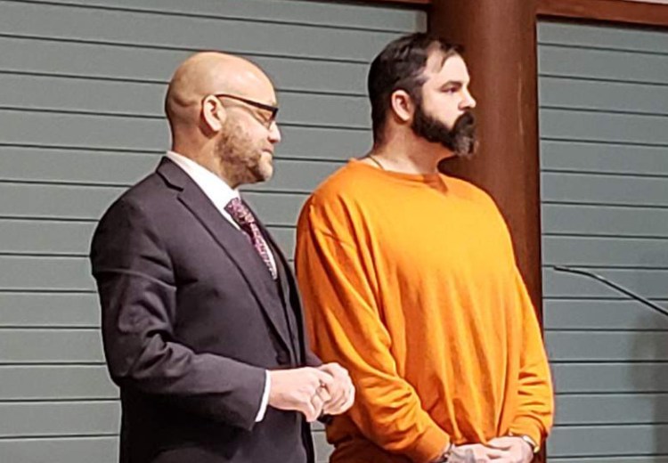 Joshua Vandine stands next to his attorney David Sinclair in court on Friday. 