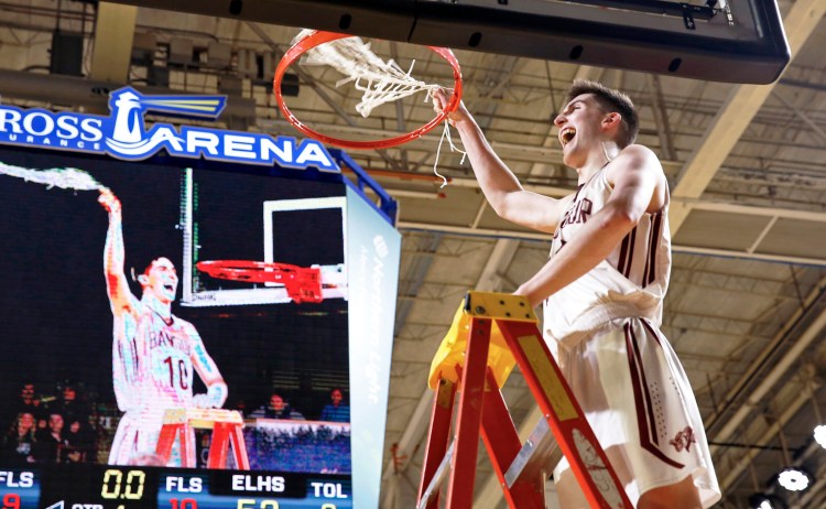 Bangor's Matthew Fleming swings the net after winning the Class AA North final against Edward Little on Friday at Cross Insurance Arena. (Portland Press Herald photo by Ben McCanna)