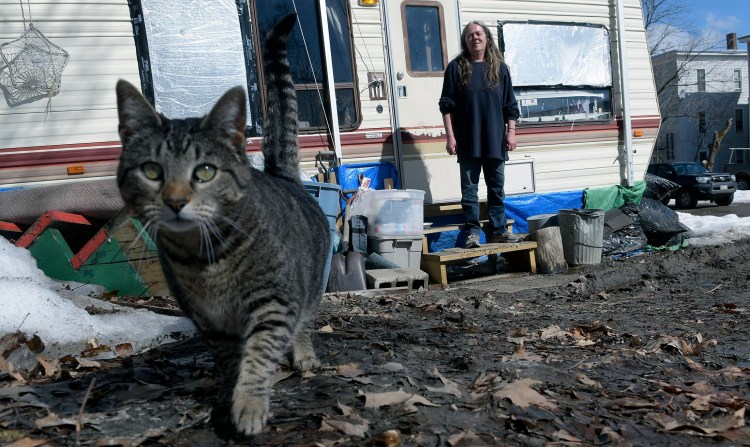 Lana Stafford waits for her cat outside the camper in which she resides in Augusta. The Augusta City Council discussed regulating how long people can live in campers in the city at its meeting Thursday night.