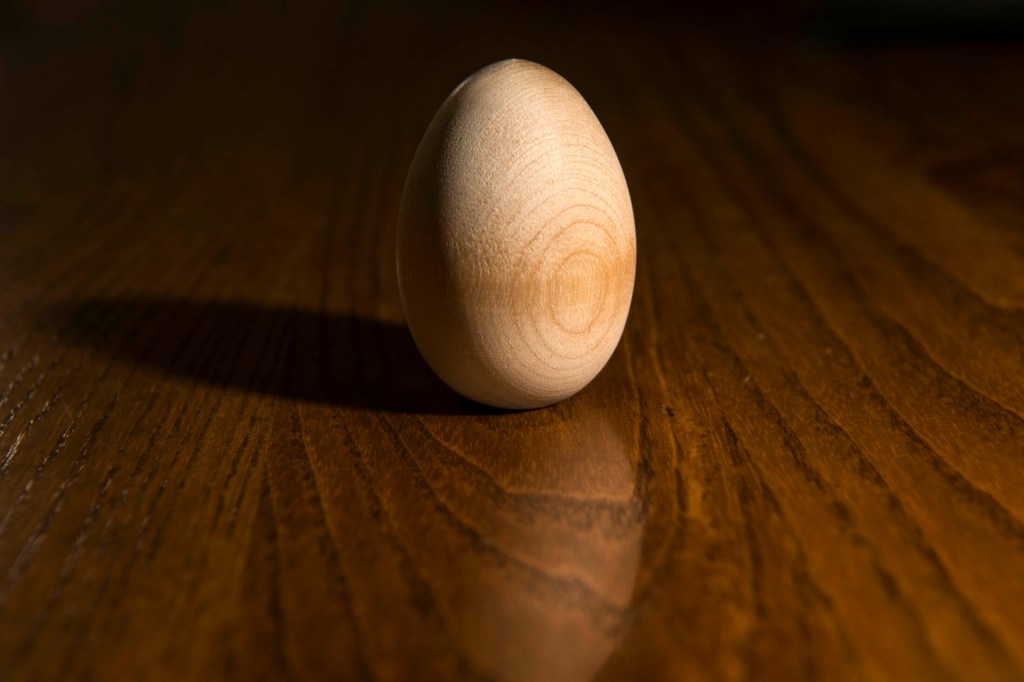 An Easter egg after it leaves the lathe and before it receives six coats of paint sits on a table for display at Maine Wood Concepts in New Vineyard on Friday.