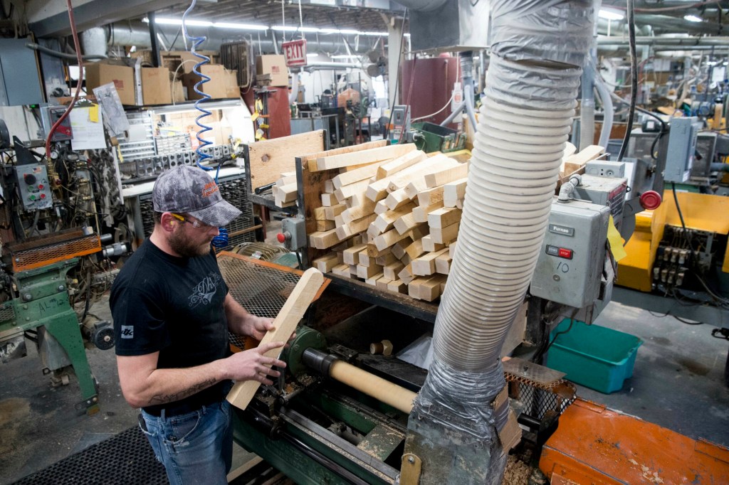 Nick Fletcher, production supervisor at Maine Wood Concepts in New Vineyard. runs the lathe to create wooden Easter eggs on Friday.