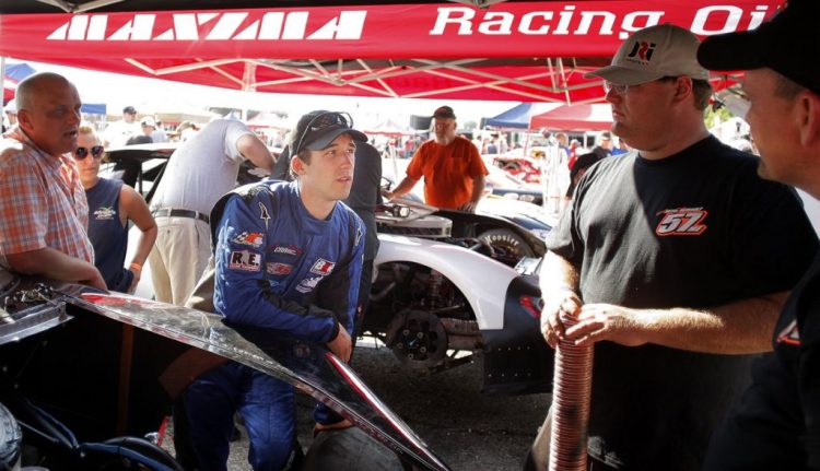 Austin Theriault, center, chats with his crew before the start of the 2013 Oxford 250 at Oxford Plains Speedway.