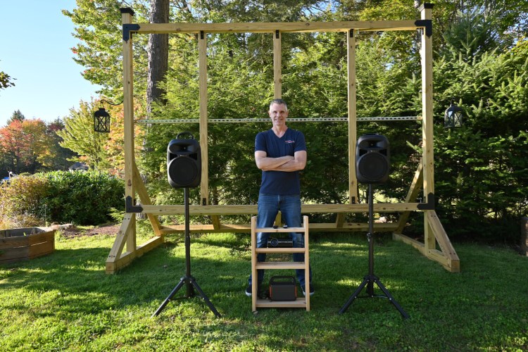 Todd Morton in front of one of his 150-inch Big Moose Premier Timberline Outdoor Cinemas