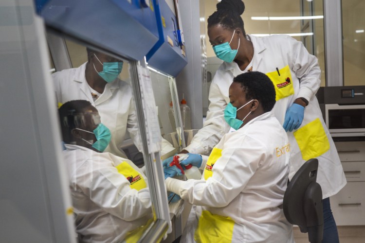 Melva Mlambo, right, and Puseletso Lesofi, both medical scientists, prepare to sequence COVID-19 omicron samples at the Ndlovu Research Center in Elandsdoorn, South Africa, on Wednesday.