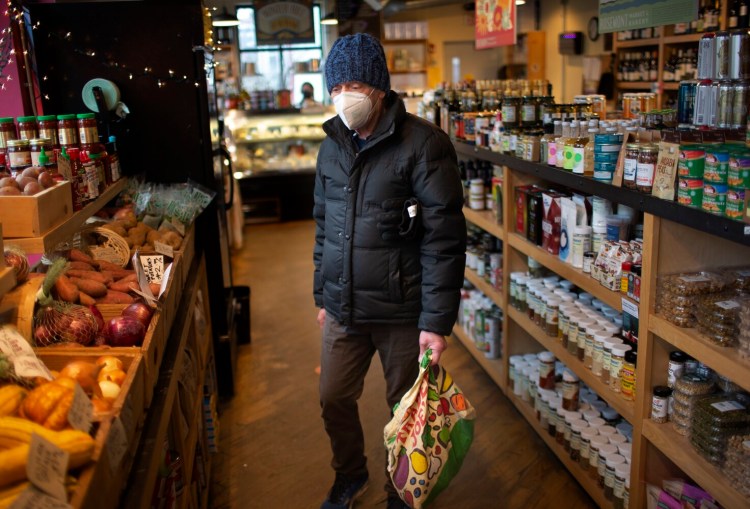 Rick Ackermann of Portland shops at Rosemont Market & Bakery on Pine Street on Monday afternoon. He said he was in favor of the city’s indoor mask mandate for public spaces.