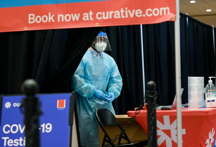 Benjamen Mboyam works the COVID-19 testing site at the Portland International Jetport on Jan. 23.