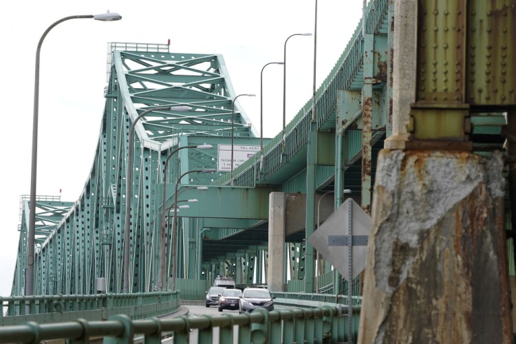 Drivers take an exit ramp off the Tobin Memorial Bridge in March in Chelsea, Mass. The Transportation Department is launching a $27 billion program to repair and upgrade roughly 15,000 highway bridges as part of the infrastructure law approved in November. The effort is being announced Friday as President Biden tries to showcase how his policies are delivering for the public. 