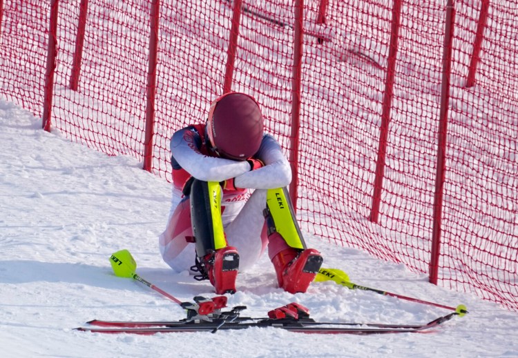 Mikaela Shiffrin of the United States sits on the side of the course after skiing out in the first run of the women’s slalom at the Winter Olympics on Wednesday in Beijing. Shiffrin missed a gate early and skied out for her second straight race. 