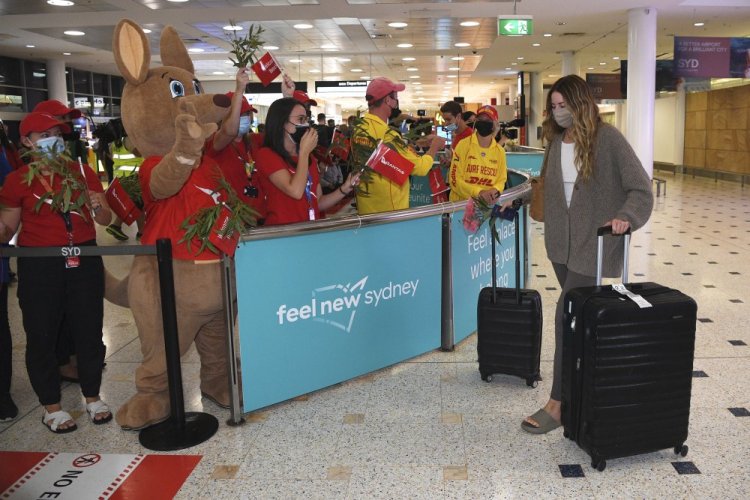 Passengers are welcomed as they arrive at Sydney International Airport on Monday.


