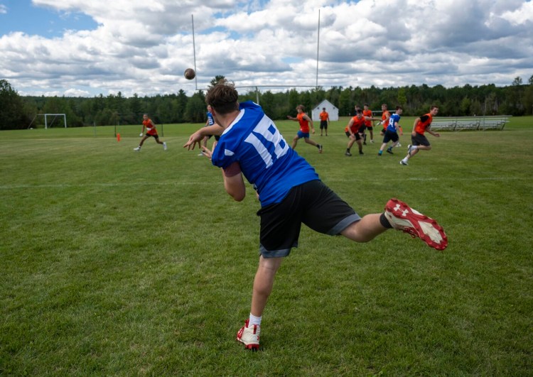 Madison quarterback Jacob Helinski (18) makes a pass on July 30 at Skowhegan High School.