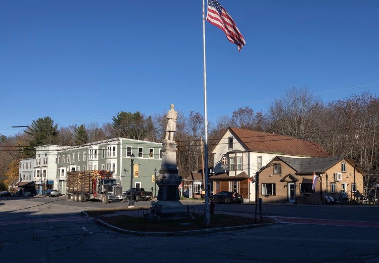 A logging truck drives down Main Street in Wilton on Thursday.