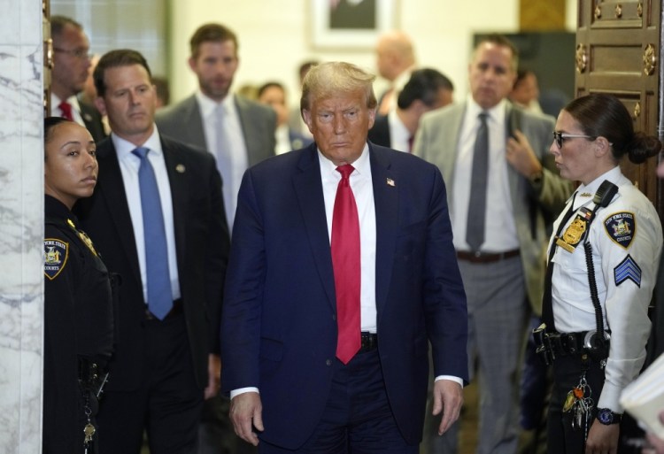 Former President Donald Trump leaves the courtroom at the lunch break in his civil business fraud trial at New York Supreme Court on Tuesday in New York. 