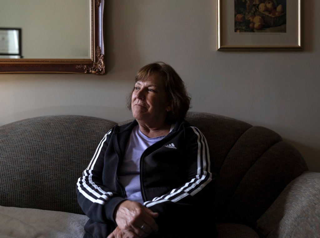 A woman sits on a couch.